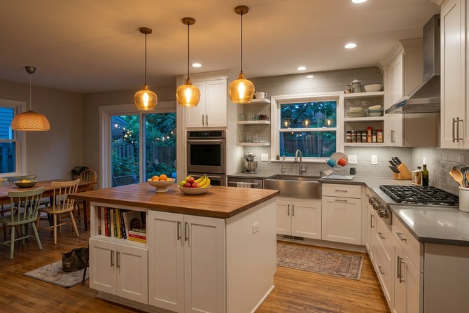 Well-lit modern kitchen with recessed lighting and pendant lights glowing warm